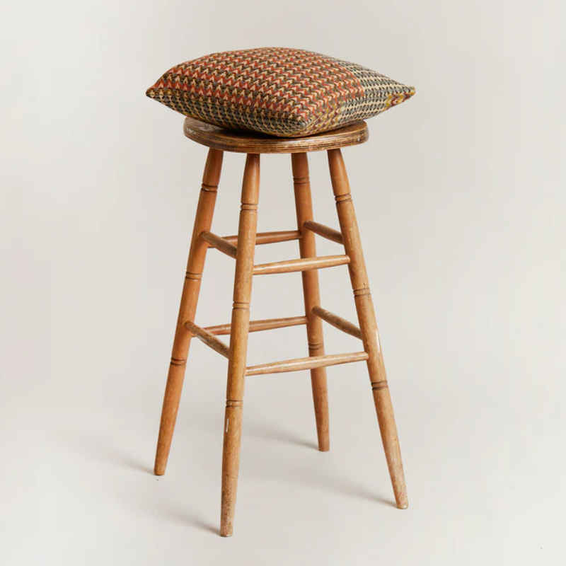 The Yosemite Cushion by Wallace & Sewell on a stool.