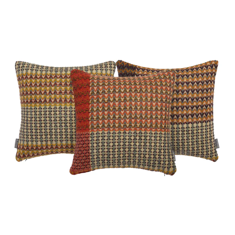 The Yosemite Cushion by Wallace & Sewell is made of Shetland Wool. Image shows three colorways of the same cushion.