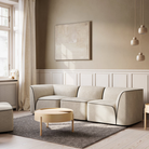 The Flora 3 seater standard in light sand in a living room.