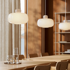 Three Stone Glass Pendants in the size Large by Woud over a dining table.