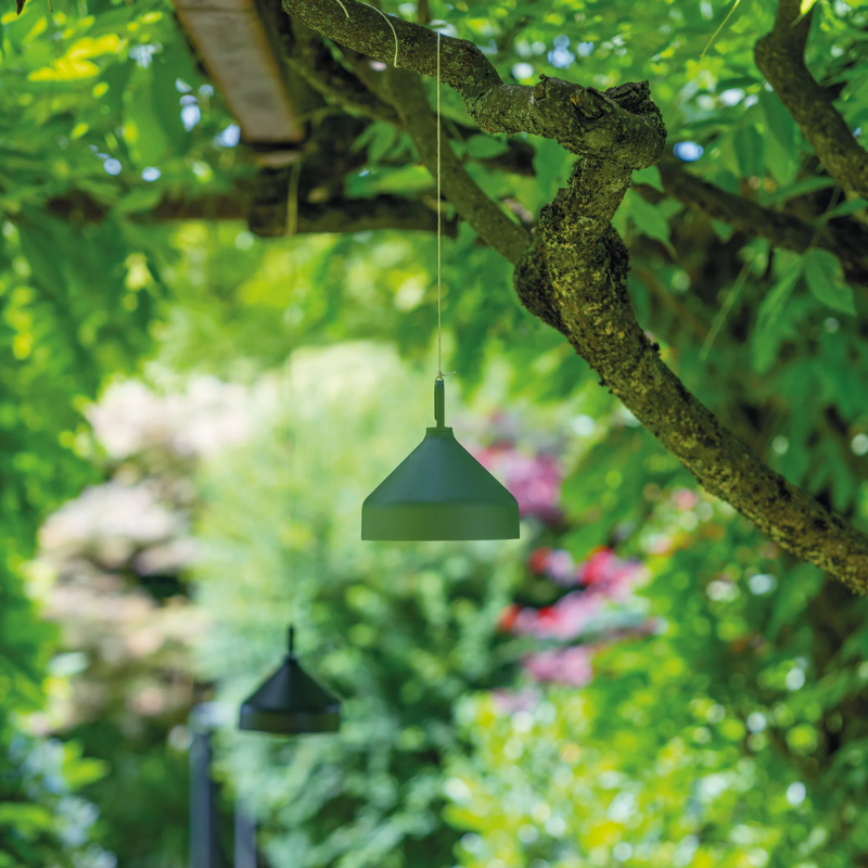 The mint green Amelie Pro Hanging Lamp from Zafferano in an outdoor living area.