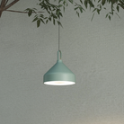 The mint green Amelie Pro Hanging Lamp from Zafferano in a living space.