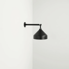 The black Amelie Pro Wall Lamp from Zafferano is wall-mounted.