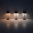 The rust Ofelia Pro cordless lamp from Zafferano showing the three color temperatures of the lamp.