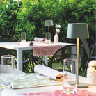 The sage Ofelia Pro cordless lamp from Zafferano in a cafe.