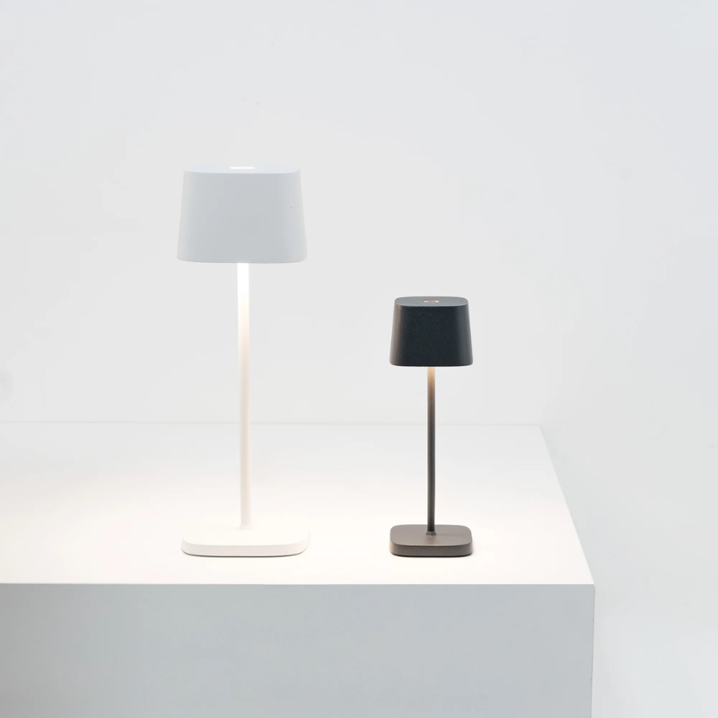 The white Ofelia Pro cordless lamp from Zafferano in a studio.