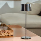 The black chrome Olivia Pro cordless lamp from Zafferano in a lounge.