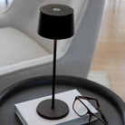 The black Olivia Pro cordless lamp from Zafferano on an end table.