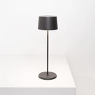 The dark gray Olivia Pro cordless lamp from Zafferano on a tabletop.