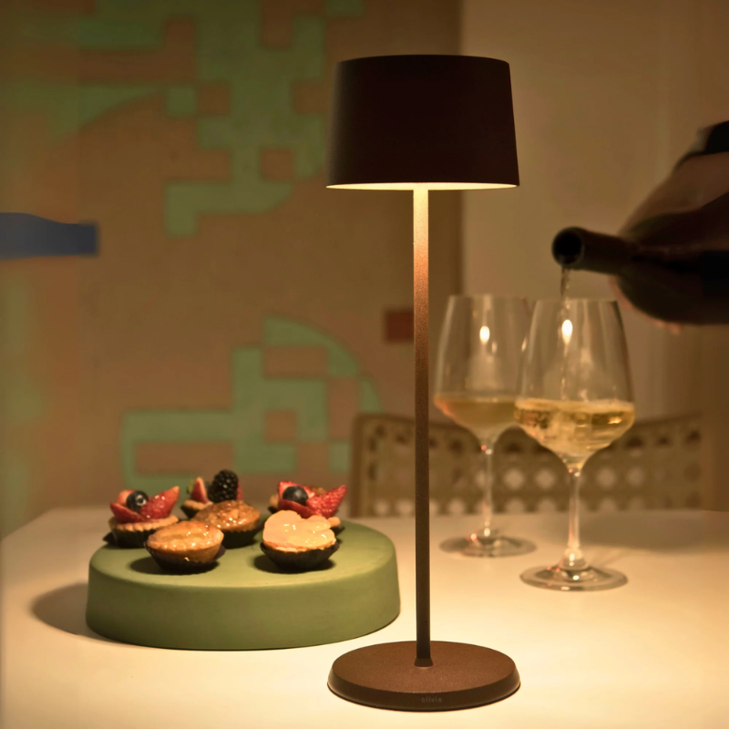 The rust Olivia Pro cordless lamp from Zafferano in a dining room.