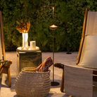 The rust Pina Pro Floor Stand from Zafferano in the outdoor lounge seating area.