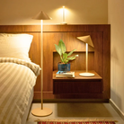 The gold Pina XXL Floor Lamp from Zafferano in the bedroom.
