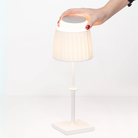 The white Polinda Classic from Zafferano with hand holding.