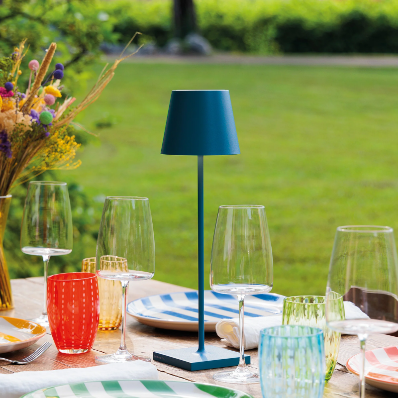 The avio blue Poldina Pro from Zafferano on an outdoor table.