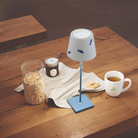 The Poldina Pro Lido with fish design and light blue base from Zafferano in a dining room.