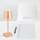 The copper leaf Poldina Pro Mini from Zafferano in a home office.