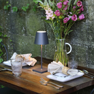 The dark gray Poldina Pro Mini from Zafferano in a cafe.