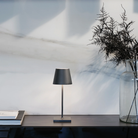 The dark gray Poldina Pro Mini from Zafferano in a home office.