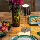 The glossy chrome Poldina Pro Mini from Zafferano in a dining room.