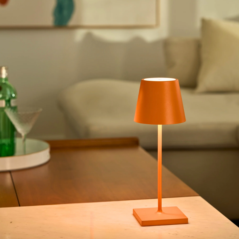 The orange Poldina Pro Mini from Zafferano in a living space.