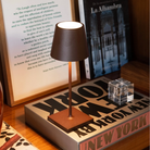 The rust Poldina Pro Mini from Zafferano in a home library.