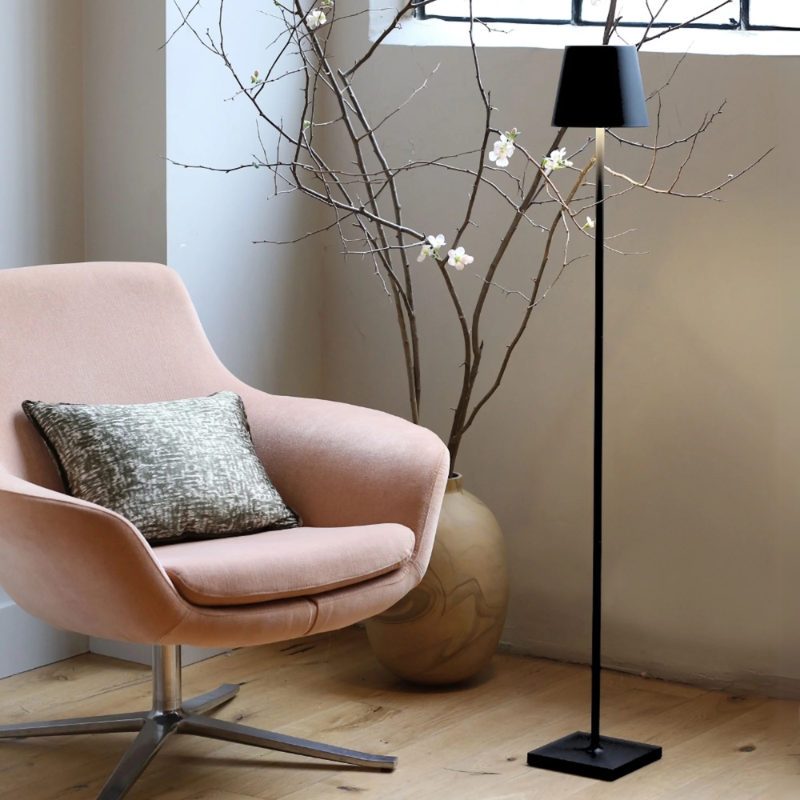 The black Poldina Pro L Floor Lamp from Zafferano in a home office.