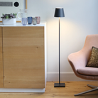 The dark gray Poldina Pro L Floor Lamp from Zafferano in a family space.