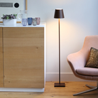 The rust Poldina Pro L Floor Lamp from Zafferano in a primary bedroom.