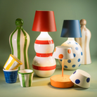 The red and blue Poldina Pro Stopper from Zafferano among Zafferano bottles and lights. all-groups