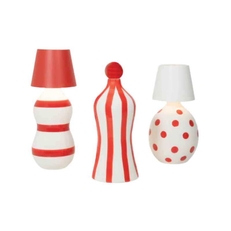 The red and the white Poldina Pro Stopper from Zafferano with decorative bottles in a studio. all-groups