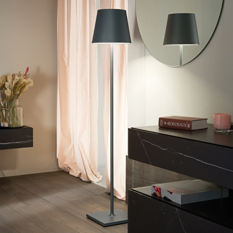 The dark gray Poldina Pro XXL Floor Lamp from Zafferano in a primary bedroom.