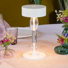 The white with clear and gray glass Royal Family Wi-Fi Table Lamp from Zafferano in a living room.