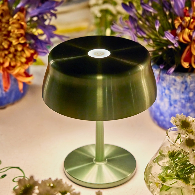 The anodized green Sister Light Mini from Zafferano in a lounge space.