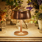 The anodized copper Sister Light Mini from Zafferano in a lounge space.