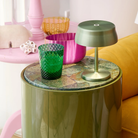 The anodized green Sister Light Mini Wi-Fi Table Lamp from Zafferano in a family space.
