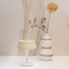 The ivory Sister Light Mini Wi-Fi Table Lamp from Zafferano in a primary bedroom.