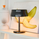 The pearl black Sister Light Mini Wi-Fi Table Lamp from Zafferano in a living area.