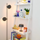 The pearl black Sister Light Mini Wi-Fi Table Lamp from Zafferano in a living room.