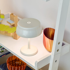 The white Sister Light Mini Wi-Fi Table Lamp from Zafferano in a dining room.