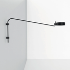 The long black Super O Wall Lamp from Zafferano is mounted in the hall.