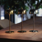 The polished chrome Theta Pro from Zafferano in a garden with other Theta colors.