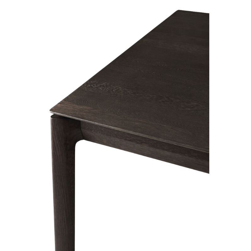 The Bok Dining Table from Ethnicraft in brown oak, in a detailed close-up.