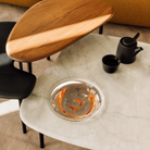 The low carrara marble table with bowl, mid black and high walnut Cyclade Tables from Herman Miller.