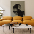 The low carrara marble table with bowl, mid black and high walnut Cyclade Tables from Herman Miller in a living space.