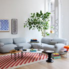 Three of the Cyclade Tables from Herman Miller within a lounge area.