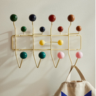 The Eames Hang-It-All rack from Herman Miller, designed by Herman Miller x Hay being used to hang a bag.