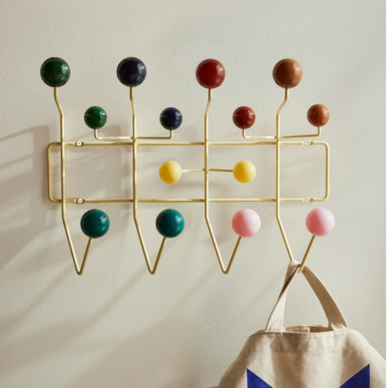 The Eames Hang-It-All rack from Herman Miller, designed by Herman Miller x Hay being used to hang a bag.