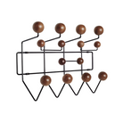The Eames Hang-It-All, originally released in 1953, exemplifies the Eameses' belief in taking pleasure seriously. Made with a sturdy steel frame and solid wood balls, this colorful coat rack was created using the same technique for simultaneously welding wires that Charles and Ray developed for their low tables and wire chairs.