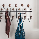 The Eames Hang-It-All from Herman Miller in a hallway, next to a door.