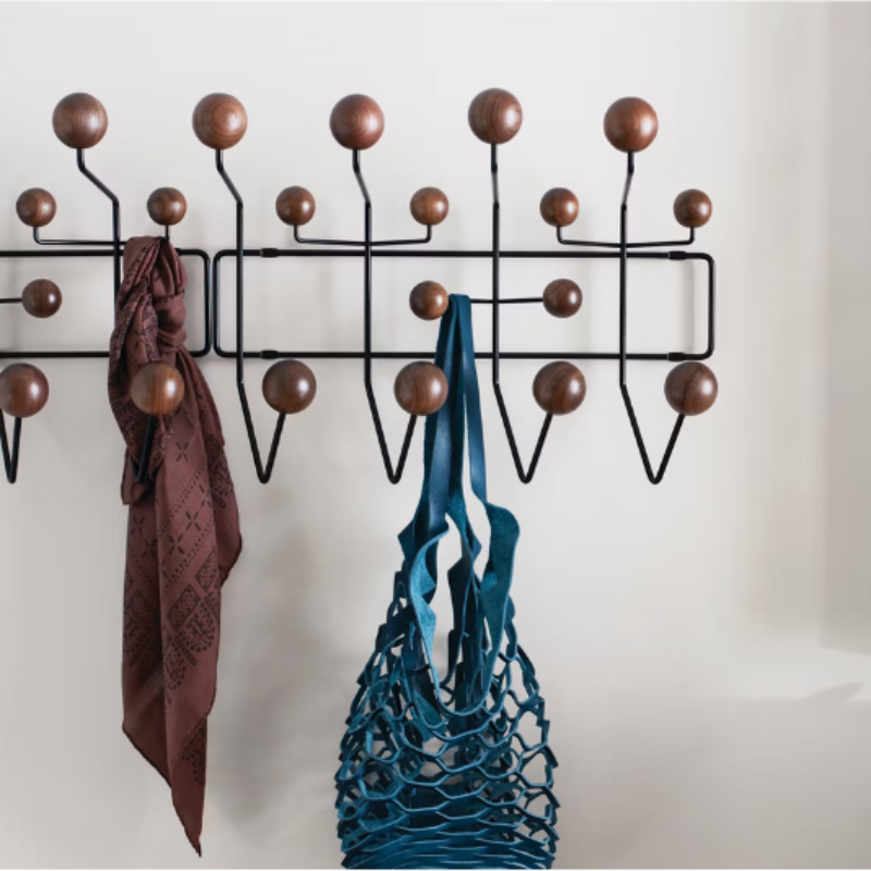 The Eames Hang-It-All from Herman Miller in a hallway, next to a door.